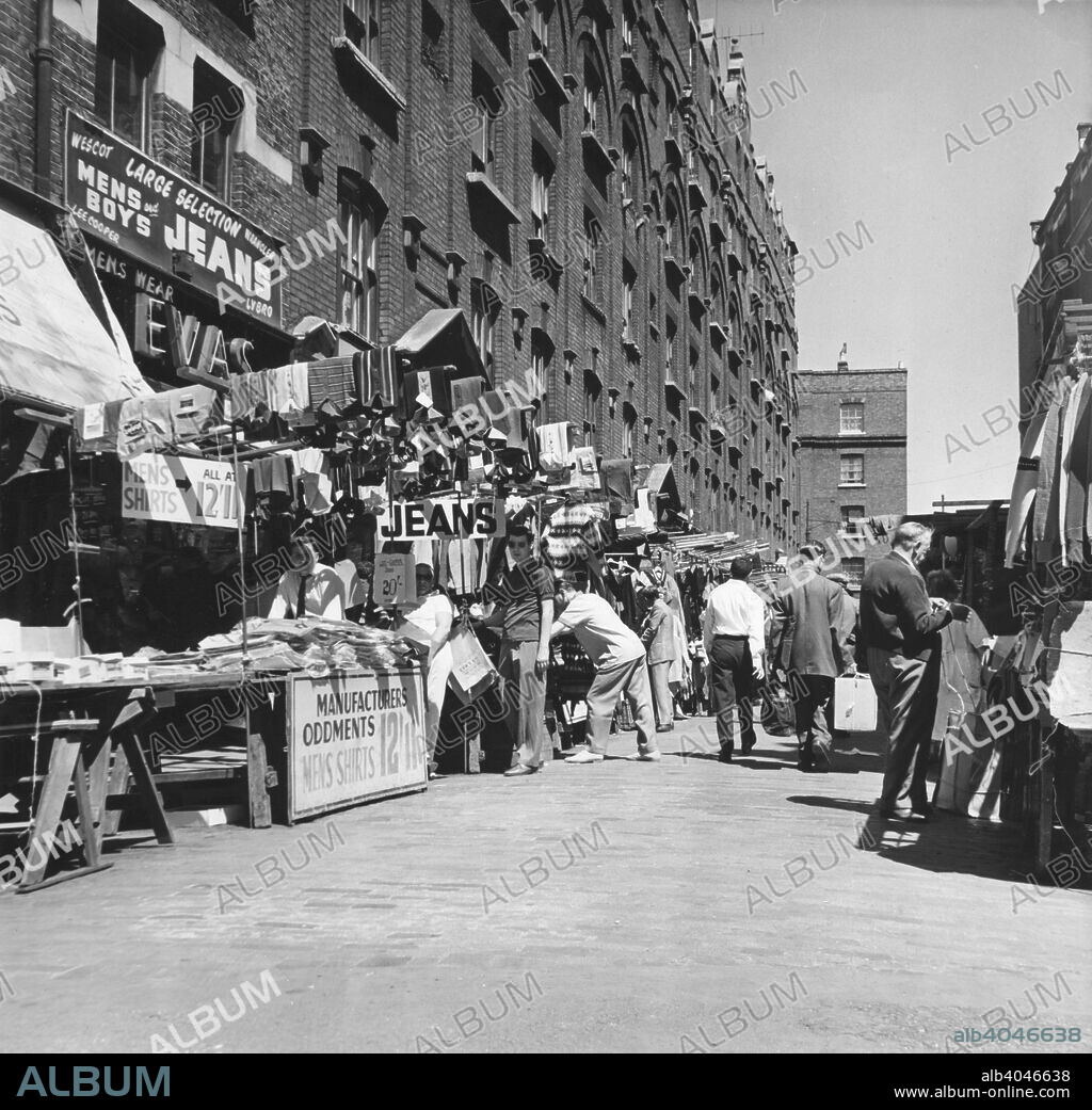 Petticoat Lane market, London, c1964. Clothing stalls at the famous East End street market.