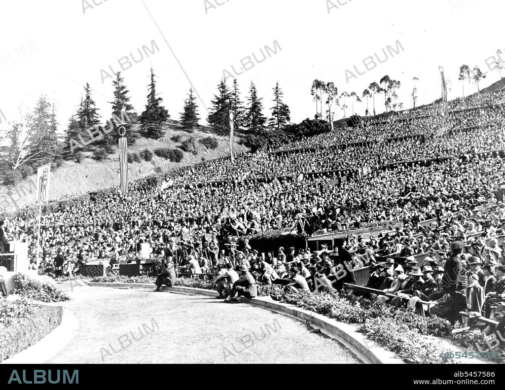 Madame Chiang Kai-Shek Addresses 30,000 Persons In Hollywood Bowl -- Madame Chiang Kai-Shek, wife of the Generalissime of China, is shown at the left addressing the largest audience of her tour of the United States in Hollywood, American movie center. An audience of 30,000 men and women filled Hollywood Bowl to capacity to hear her pledge that China would fight until final victory is won and then play its port in a just and lasting peace. June 21, 1943. (Photo by Office Of War Information).