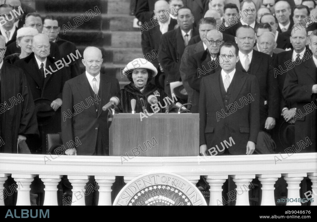 Photograph shows singer Marian Anderson performing at the Eisenhower Inauguration, as President Eisenhower and Vice President Richard Nixon stand behind her. 1957.