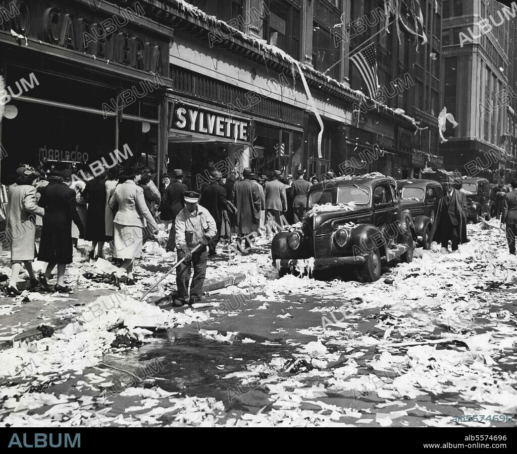 Aftermath -- ****** Sixth-street and Sixth-avenue, New York City, presented a problem to the lone street cleaner of clearing away paper tossed about by merrymakers celebrating the end of the war in Europe. July 5, 1945. (Photo by Associated Press Photo).