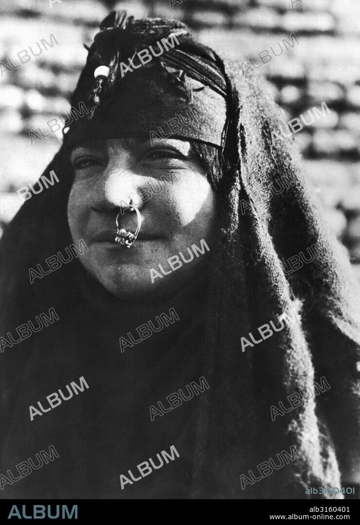 Baghdad, Iraq: May 22, 1932 A 22 year old Arab woman in Baghdad showing her jeweled nose ring.