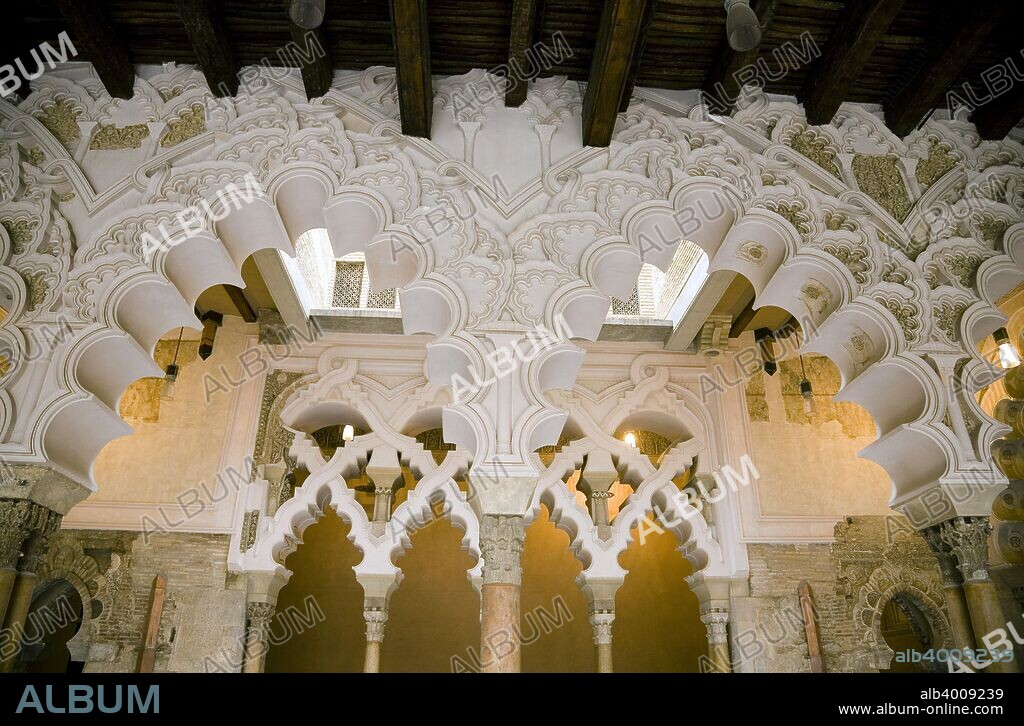 Interior view, Aljaferia Palace, Zaragoza, Spain. The Aljaferia Palace is a fortified palace that was built during the second half of the 11th century in Zaragoza by Abu Jafar Ahmad ibn Sulayman al Muqtadir billah (1047-1082), as the residence of the Banu Hud dynasty. It was originally named Dar al Surur (House of Joy). The name Aljaferia derives from al-Jafariyya, after the name of its founder. The structure holds unique importance in that it is the only conserved testimony of a large building of Spanish Islamic architecture in the era of the Taifas (independent Islamic kingdoms). The most remarkable feature of the Aljaferia is in the systems of interlacing arches with a high degree of complexity. In 2001 Aljaferia Palace was added to the category of Mudejar Architecture of Aragon, that was awarded a World Heritage Site status by UNESCO.