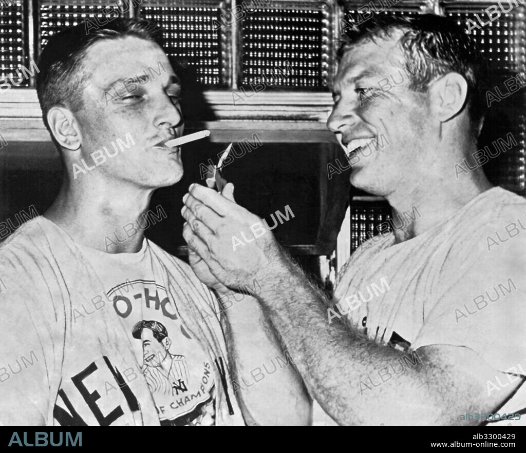 New York, New York:  July 13, 1961.New York Yankee slugger Roger Maris gets a light for his cigarette from teammate Mickey Mantle after they hit back to back home runs in the first inning against the Chicago White Sox.