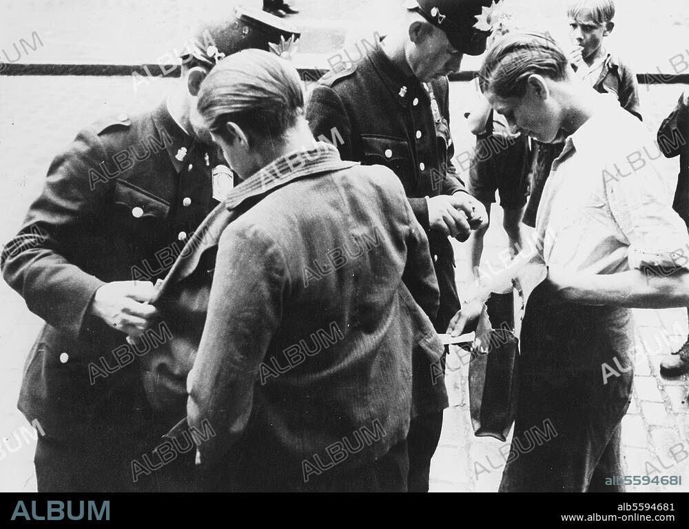 Post-war Berlin / 1946. Youths being searched by the police for black market goods. Photo, 16/9/1947.