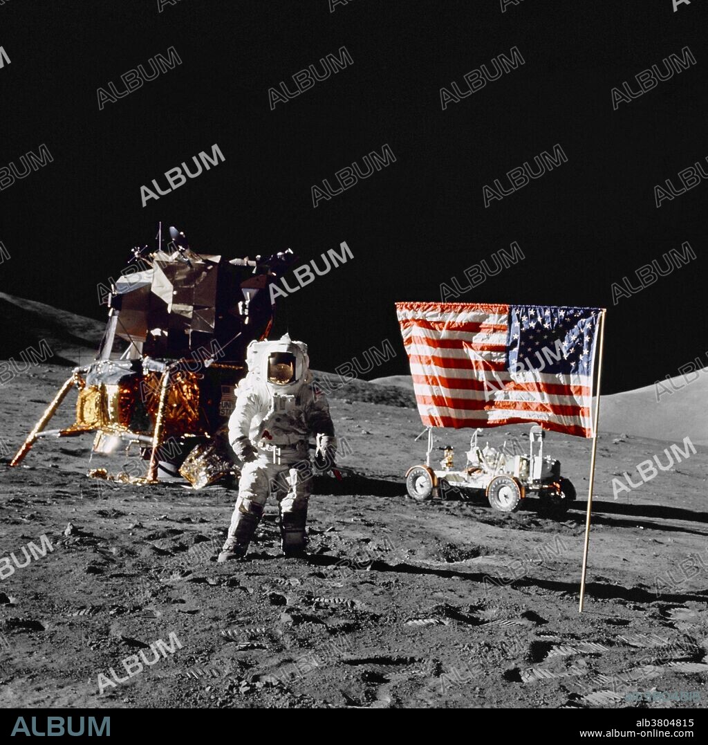 Astronaut Harrison H. Schmitt, Apollo 17 lunar module pilot, stands near the deployed United States flag on the lunar surface during extravehicular activity (EVA) of NASA's final lunar landing mission in the Apollo series. The Lunar Module (LM) is at left background and the Lunar Roving Vehicle (LRV) at right background (partially obscured). The photo was made by astronaut Eugene A. Cernan, commander. While astronauts Cernan and Schmitt descended in the LM "Challenger" to explore the Taurus-Littrow region of the moon, astronaut Ronald E. Evans, command module pilot, remained with the Command and Service Modules (CSM) "America" in lunar orbit.