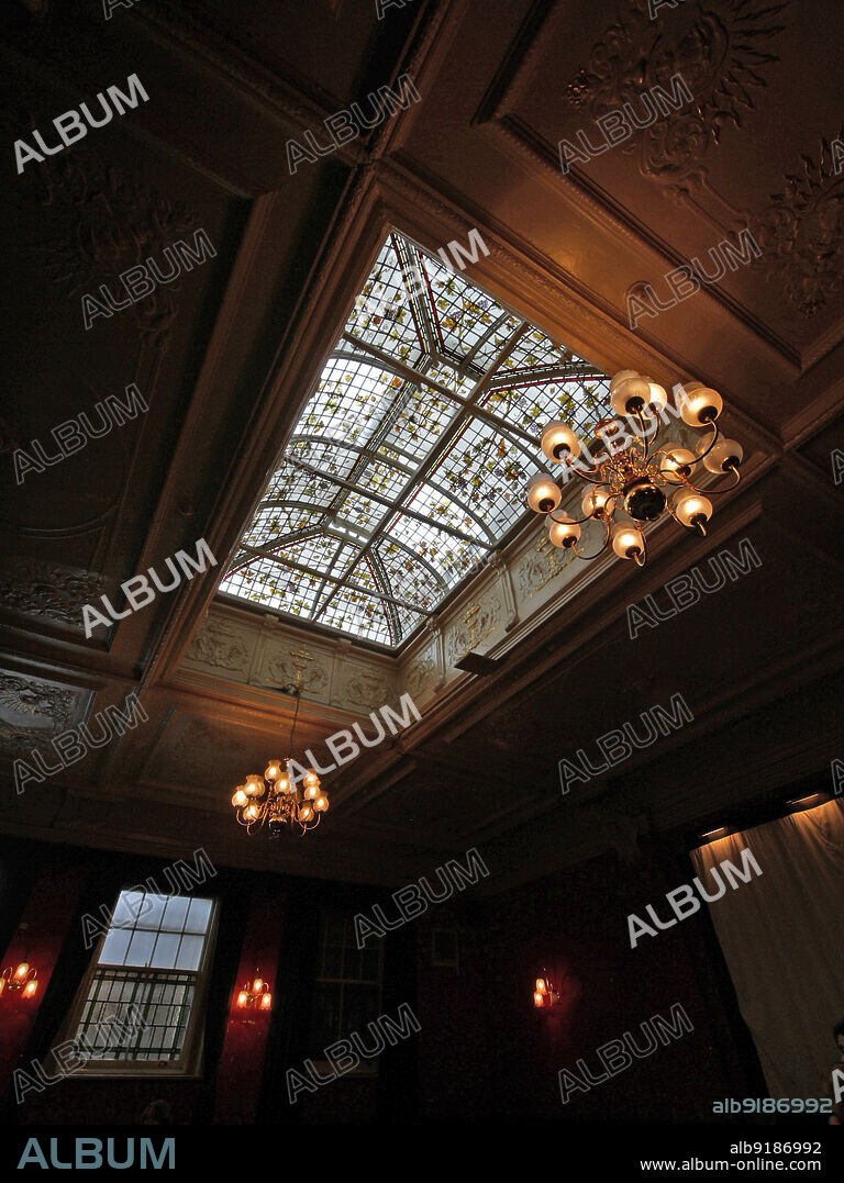 SIMON INGLIS. The Salisbury Hotel, Green Lanes, Harringay, Greater London Authority, 2011. The large roof light and decorative plasterwork in the former billiard hall of The Salisbury Hotel, Harringay. The Salisbury Hotel was built in 1898-1899 by John Cathles Hill. It is Grade II* listed. The billiard hall was lit by a large roof light with painted glass depicting a creeping vine motif.