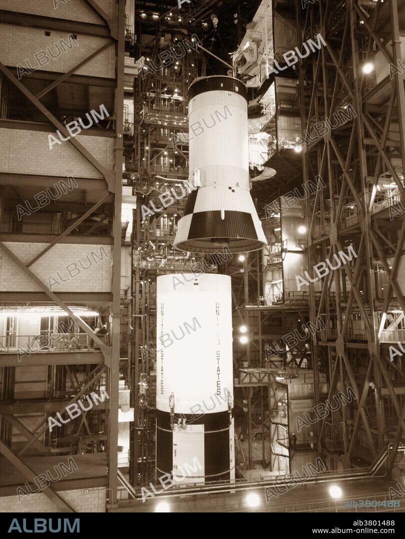 Apollo 11 launch rocket. Assembly of the Saturn V rocket used to launch the Apollo 11 mission, the first manned mission to land on the Moon. The rocket's third (S-IVB) stage is shown here being hoisted onto the second (S-II) stage. The second and third stages are used to continue a Saturn V's journey to the Moon after the first stage has burned out and separated from the rest of the rocket. The astronauts aboard the Apollo 12 mission (16-24 July 1969) were Neil Armstrong, Edwin Aldrin and Michael Collins. March 5, 1969.