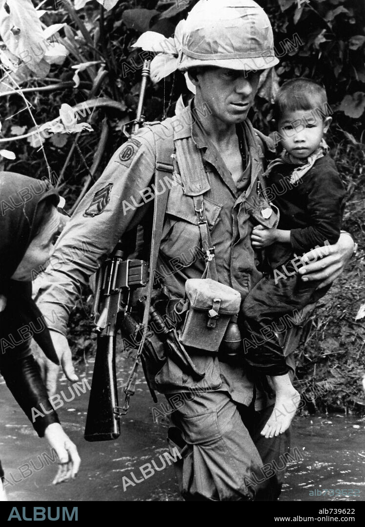 Aug 05, 1967; An Rha, Vietnam; A member of the 1st Cav Division helps a Vietnamese woman and child across a stream near An Rha. In the 1950's, the US began to send troops to Vietnam, during the following 25-year period, the ensuing war would create some of the strongest tensions in US history. Almost 3 million US men and women were sent to fight for what was a questionable cause. In total, it is estimated that over 2,5 million people on both sides were killed. Mandatory Credit: Photo by KPA / ZUMA Press. (. 05/08/1967