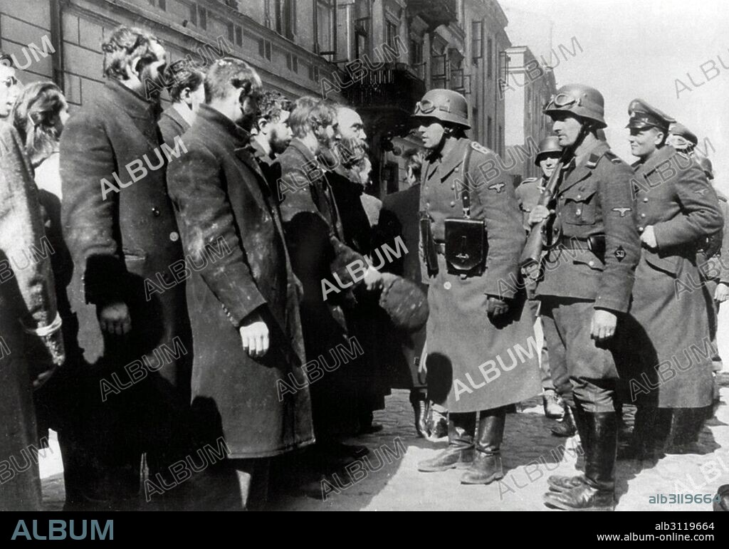 Photograph from Nowolipie Street with Josef Blösche (1912-1969) member of the National Socialist German Workers Party, stopping Jewish Rabbis. Dated 1940.