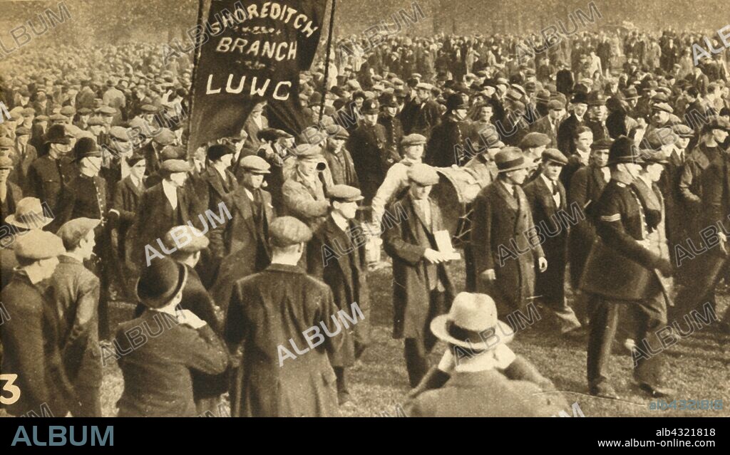Marchers from Shoreditch, Means Test protests, Hyde Park, London, 1932, (1933). 'The Shoreditch contingent arrives at Hyde Park'. The National Hunger March of September to October 1932 was the largest of a series of hunger marches in Britain. The unemployment rate having reached 2,750,000, the 1932 National Unemployed Workers' Movement organised Great National Hunger March against the Means Test, marching from the South Wales Valleys, Scotland and the North of England to Hyde Park in London. From "The Pageant of the Century". [Odhams Press Ltd, 1933].