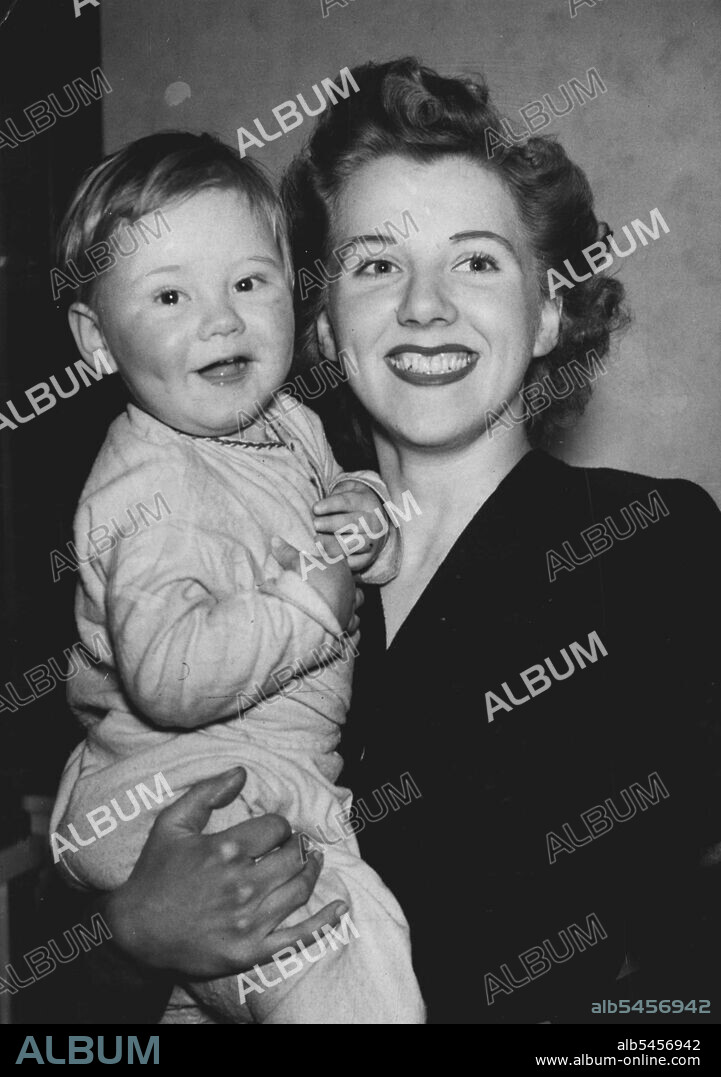 Happily Married But Another Husband is wanted - 24-year-old Mrs. Doris Palmer, here seen with her 18-month-old son, Robin, is a happily married woman but another husband is wanted for her. Husband No 2 is someone who can play opposite her in a film about Islington, London, housing problems. Mrs. Palmer, who lives in Islington, has been selected to play the part of a typical young housewife in search of a home. The film, sponsored by the local council, will show how to get to grips with the housing problem. In real life Mrs. Palmer is herself 1ooking for a home because the one she is in is not big enough. March 29, 1950. (Photo by Paul Popper Ltd.).
