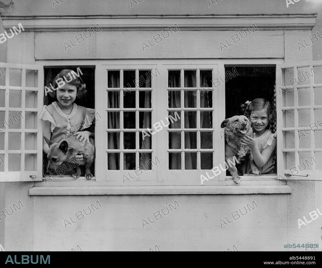 Royal Lodge Windsor. June 1936. - Queen Elizabeth & Princess Margaret at Windsor. Fashion change, even in Royal photographs. Contracts this made in 1936 and one of the first Royal Family "snaps" taken by Mrs. Sheridan, with the natural, unposed picture of Prince Andrew made last month. The Royal preference for corgis remains unchanged. June 15, 1953. (Photo by Camera Press Ltd.).