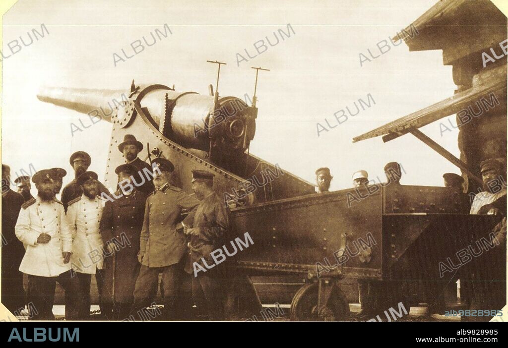 Mining chief of the Perm Cannon Plants Nikolai Gavrilovich Slavyanov in a group of plant engineers and artillery acceptance officers at the factory range. The background is an experimental 6-inch coastal gun with a barrel length of 35 calibers of the 1887 model of the Brink system. The gun was made on Perm Cannon Plants in a single copy together with a carriage in 1891. An interesting fact is that the carriage of this gun is riveted, although at the PPZ at that time electric welding was already widely used according to the Slavyanov method ca. from 1890 until 1897.