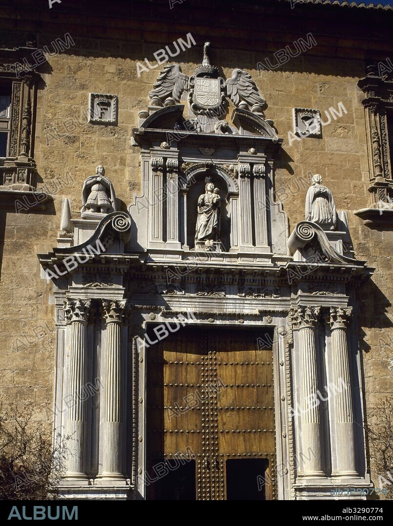 Spain, Andalusia, Granada. Royal Hospital. It was founded by the Catholic Monarchs who comissioned the building in 1504. Designed by the architect Enrique Egas, it was built in 1511. View of the Renaissance facade with Plateresque decoration and a Baroque portico. The facade was constructed with marble from Sierra Elvira, and carried out by Juan Garcia de Pradas. Four Corinthian columns and, over, ther image of the Virgin Mary and statues of Isabel and Fernando in kneeling position, sculpted by Alonso Mena. The coat of arms of the Catholic Monarchs is on the upper part.