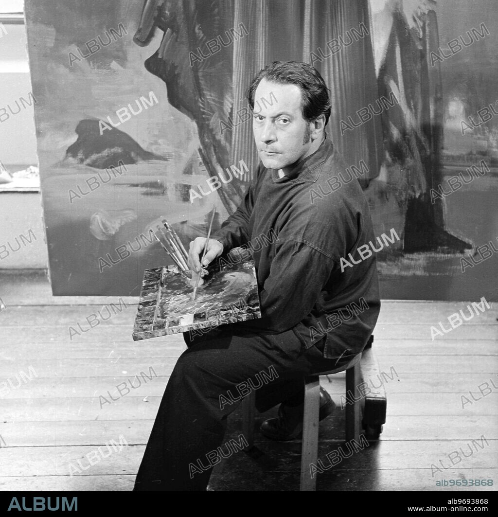 Original 1950 caption. Signor Pietro Annigoni. Signor Pietro Annigoni is recognised as one of the outstanding painters of this century , and he is acclaimed by the art critics for his brilliant portrait of H.M. Queen Elizabeth II . Born in Milan in 1910 he moved to Florence in 1925 , and for a short time studied at the Academie des Beaux Arts . PICTURE SHOWS:- Another study of Signor Pietro Annigoni photographed in his London studio . 1956.