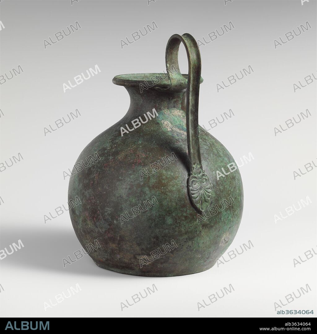 Bronze oinochoe (jug). Culture: East Greek. Dimensions: H. x width  9 1/16 x 5 in. (23 x 12.7 cm)
diameter  7 in. (17.8 cm). Date: late 6th century B.C..
Handle is worked separately; it may be an ancient replacement.