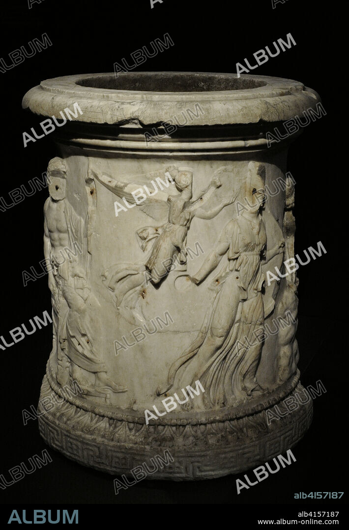 Moncloa Puteal. Well curbstone decorated with reliefs narrating the birth of Athena. Nike, the winged Victory, flies to crown Athena. It probably formed part of the decorative elements of a Roman house. From Rome, Italy. Marble. 1st century AD. Height: 99.5 cm, diameter: 84 cm. National Archaeological Museum. Madrid. Spain.