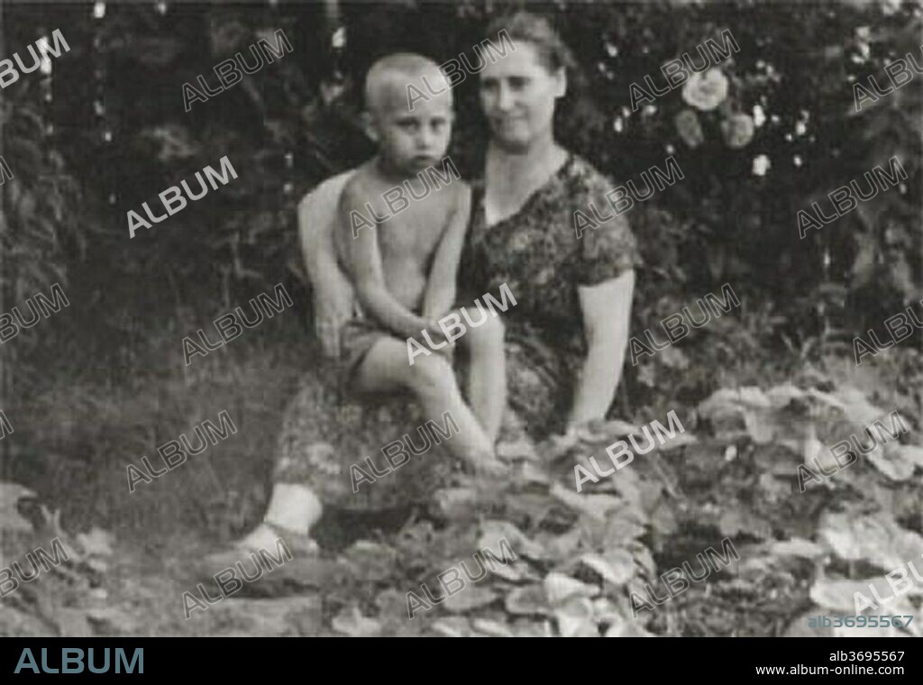 July 1958 - Russia - VLADIMIR VLADIMIROVICH PUTIN, 5, (born October 7, 1952 in Leningrad, Russian SFSR, Soviet Union (now Saint Petersburg with his mother MARIA IVANOVNA, 41, summer of 1958. The youngest of three children of Vladimir Spiridonovich Putin (1911–1999) and Maria Ivanovna Putina (née Shelomova; 1911–1998). Putin's mother was a factory worker and his father was a conscript in the Soviet Navy, serving in the submarine fleet in the early 1930s. At age 12, he began to practice sambo and judo. Speaks German fluently. Studied Law at the Saint Petersburg State University in 1970 and graduated in 1975. In 1975, joined the KGB. 11/06/2018