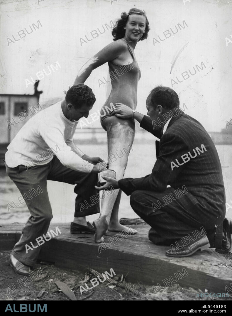 Being Readied For Battery-Coney Island Swim Shirley May France, 16, of Somerset, Mass., has a protective Grease covering applied by her high school coach, Harry Boudakian (left) and her father, J. Walter France, before starting out on an 8-mile swim from the Battery to Coney Island, New York, July 10. Shirley, holder of several women's professional swimming titles, is preparing for her attempt at swimming the English Channel this summer. The 177-***** high school sophomore comes from a swimming *****. Her father was a long distance *****. July 10, 1949. (Photo by Associated Press Photo).