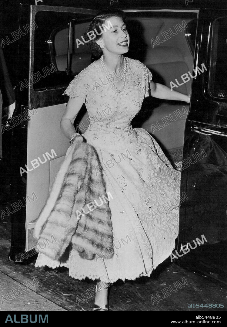 The Queen At A Party -- The Queen arrives for the party. The Queen and Duke of Edinburgh went to an 11 p.m - to 4. a.m party in Grosvenor- Square, London, on Thursday night given by the Queen's cousin, 39-year-old Mrs. John Lycett Wills. Other guests: Princess Margaret, Princess Alexandra, Mrs. Douglas Fairbanks jun., Miss Sharman Douglas - and Marlene Dietrich, who arrived at 12.30.a.m. The Queen and the Princesses were still there at 2.30. July 22, 1955. (Photo by Daily Express Picture).