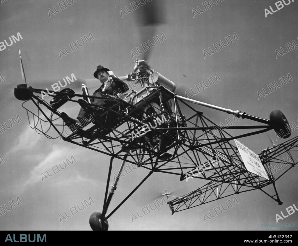 In this helicopter, inventor Igor Sikorsky literally hung in the air near Bridgeport, Conn., for one hour, 32 minutes and 30 seconds to break all existing records for this type machine. Inventor Sikorsky doesn't have to remove his hat or don a flying helmet because the down draft from the motor keeps his hat jammed to his head. May 08, 1941. (Photo by International News Photos).