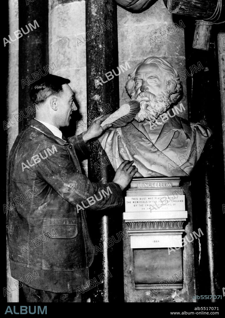 Washing Days For Poets' Corner Of Anbey -- The bust of Longfellow, one of the many of famous poets, now being cleaned at Westminster Abbey.That famous corner of Westminster Abbey trancept where Chaucer, Tennyson, Browning and other famous English poets are buried is "Closed for repairs". It is now covered with scaffolding in order that the ancient vault and walls, which are within a few years of their seven hundredth birthday, may be cleaned and the real beauty revealed. All the stone is being carefully brushed and washed and it is probable that a coating of limewash will be applied as a final touch. January 2, 1935. (Photo by Fox).