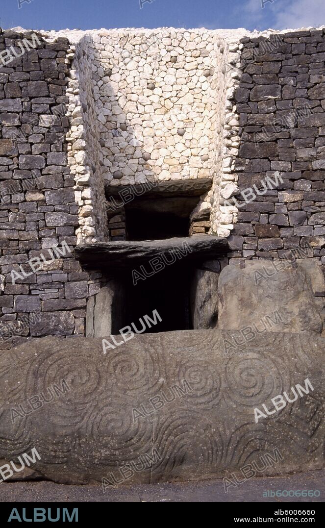 IRELAND County Meath Newgrange Entrance to Prehistoric Burial Site in the Boyne Valley with carved stone in the foreground.