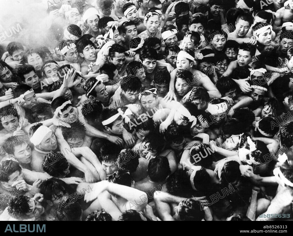 AICHI, JAPAN - 19620310. The 1 200 year old nude festival of the Konomiya Shrine in Japan. Somewhere in the middle of the 16 000 men participating, is the "man of good luck" whom everybody is trying to touch. The body temperatures of all these people became so hot that the water, thrown to cool everybody down, just turned to steam.... Photo: UPI Code: 450. COPYRIGHT SCANPIX SWEDEN.