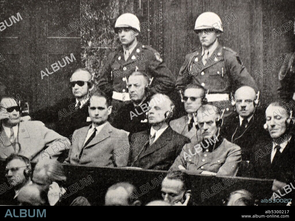 Black and white photograph of World War II (1939-1945) showing images related to the Nuremberg Trials, the largest prosecution in history, and which began in November 1945; a group of the accused awaiting trial in the Court of Justice: Goering, Hess, Ribbentrop, Keitel, Rosenberg, Doenitz, Raeder, Baldur von Schirach and Sauckel.