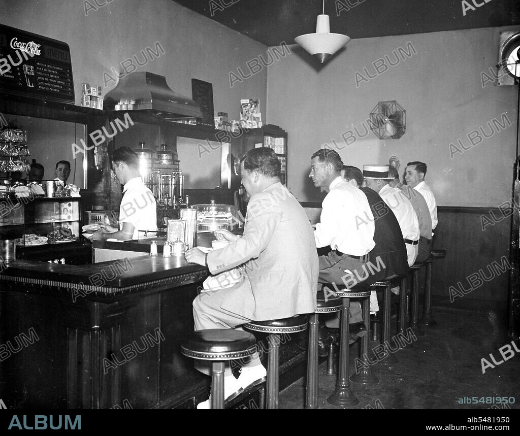 Men eating at lunch counter of restaurant inside Greyhound Bus Terminal circa 1936 or 1937.