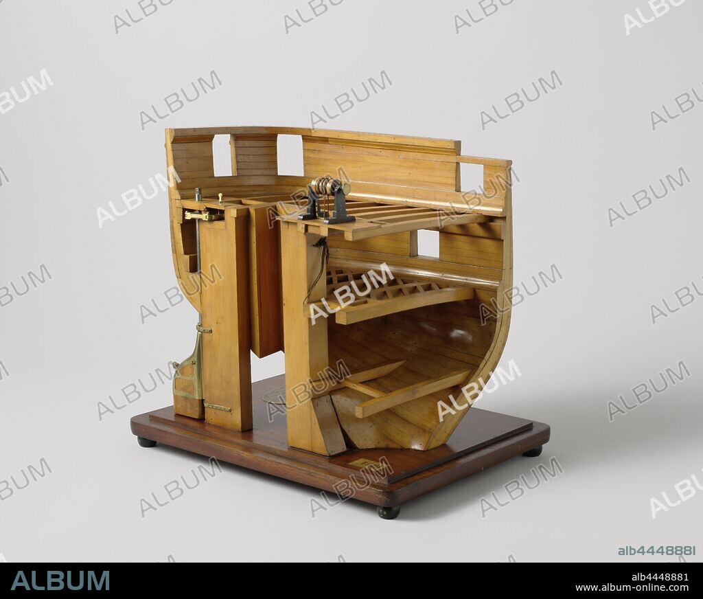 Model of Steering Gear, Truss model of the port half of a stern above the water line, which demonstrates the steering. The stern has an elliptical fence and three decks, all marked with their web, the upper deck is open. It has a large cross-shaped screw sleeve between the stern and the stern. The drum of the steering wheel is on the upper deck just in front of the propeller shaft. The steering system, which runs just below the upper deck, is a mixture of Rapson slide and slider carriage. The lower rudder pin, which is moved by the control device, is bent to be able to move in the port-side space of the screw sleeve, it is not directly connected to the rudder king, but turns on its own axis and the movement is transferred to the rudder king with two hinges. Between rails, which are arranged between the propeller tube and the ship's wall, a plate goes back and forth with a bracket loosely around the stem, driven by the handle that passes over two discs on top of this plate. The play in the bracket allows the stem to follow the movement of the plate without being hindered in the arc movement that he describes. The tension of the handlebar can be adjusted with a turnbuckle. 1:20 scale, Adolf duke of Nassau (ship), Adriaan Rosel, Rijkswerf (Willemsoord), 1867 - 1868, wood (plant material), brass (alloy), iron (metal), rope, model: h 50 cm × w 54.1 cm × d 40 cm packaging capsule: h 55 cm × w 58.5 cm × d 44.5 cm.