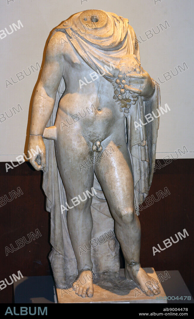 Roman statue of a young boy with a cloak. He holds grapes and may represent Autumnus. 2nd century AD, Bristol Museum.