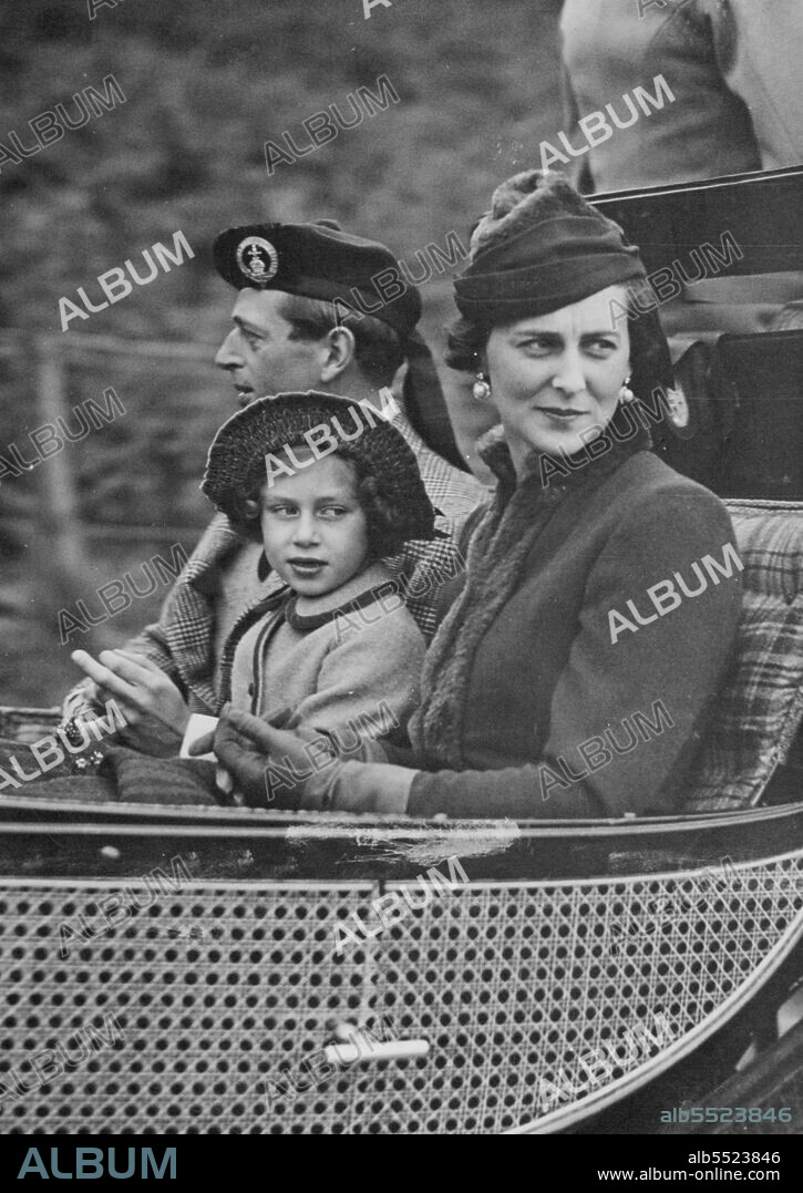King And Queen Accompanied By Duke and Duchess of Kent At Service -- The Duke and Duchess of Kent driving to Crathie Church yesterday. Between them is Princess Margaret Rose.The King and Queen were accompanied by the Duke and Duchess of Kent when they drove to Crathie Church from Balmoral yesterday. October 4, 1937. (Photo by Topical Press).