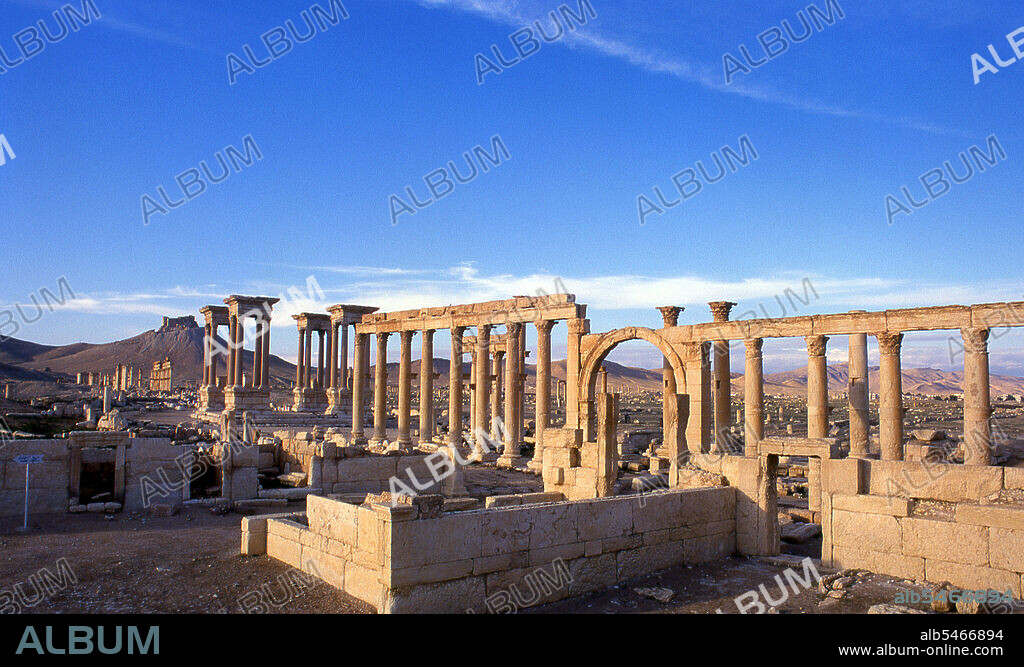 The Arab castle, Qalaat Ibn Maan (also known as Fakhr-al-Din al-Maani), situated on a hill overlooking the ruins was orignally constructed by the Mamluks in the 13th century. Palmyra was an ancient city in Syria. It was an important city in central Syria, located in an oasis 215 km northeast of Damascus and 180 km southwest of the Euphrates at Deir ez-Zor. It had long been a vital caravan city for travellers crossing the Syrian desert and was known as the Bride of the Desert. The earliest documented reference to the city by its Semitic name Tadmor, Tadmur or Tudmur (which means 'the town that repels' in Amorite and 'the indomitable town' in Aramaic) is recorded in Babylonian tablets found in Mari.