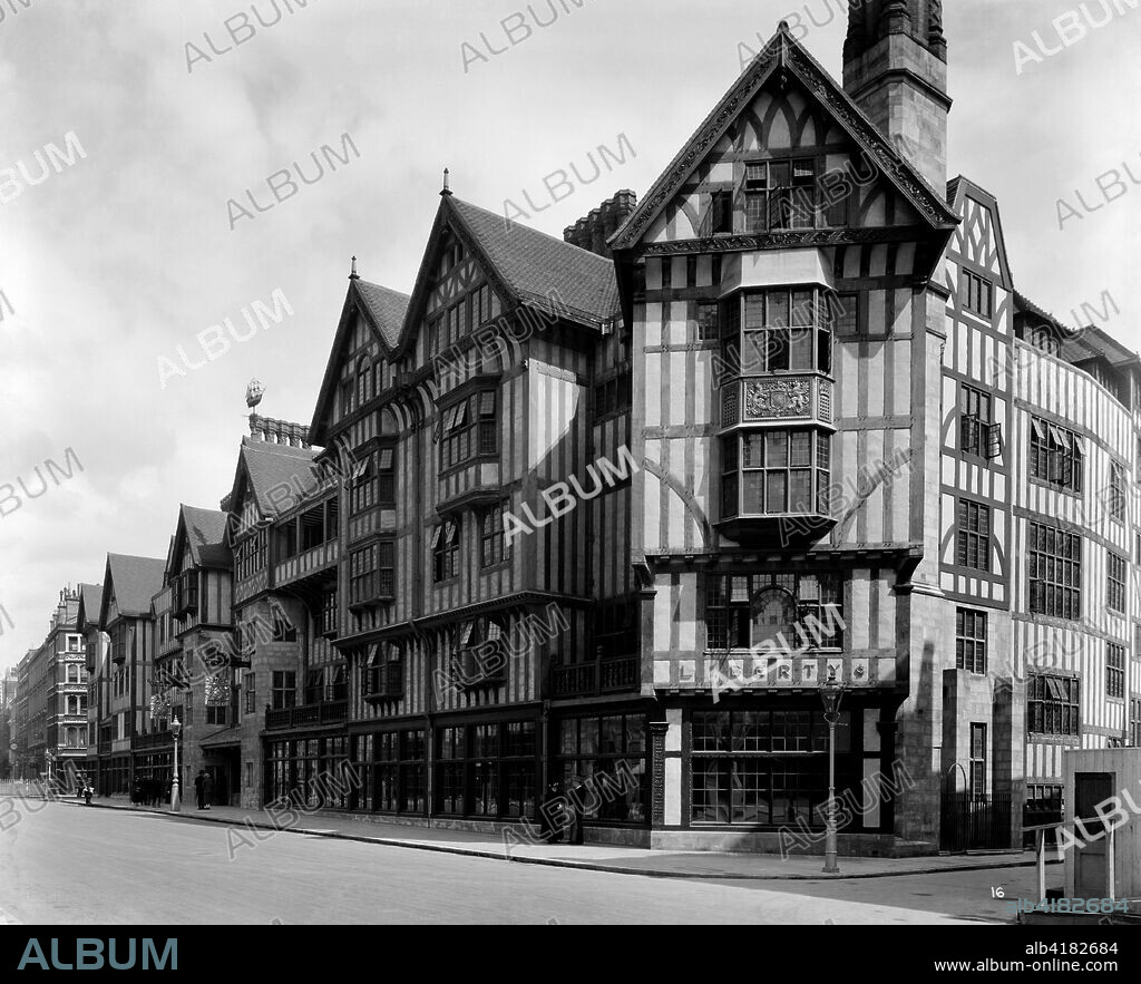 Liberty and Co department store, Regent Street, London, 1924. Exterior view showing the Great Marlborough Street facade of Liberty's newly completed Arts and Crafts Tudor style department store. Designed by Edwin T Hall and E Stanley Hall, this extraordinary building was constructed in 1922-1924 using timbers from HMS 'Hindustan' and HMS 'Impregnable'. It was a remarkable reaction to the early 20th century vogue for stone dressed steel-framed buildings. This photograph was commissioned by Higgs and Hill, builders.