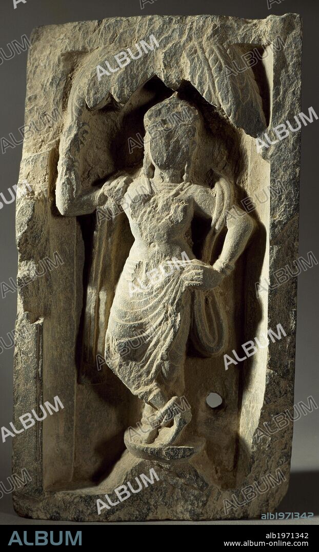Buddhist with Yakshini or vegetation genius, shale Greek sculpture, Afghanistan. Gandhara Civilisation, 1st century BC- 3rd century AD.