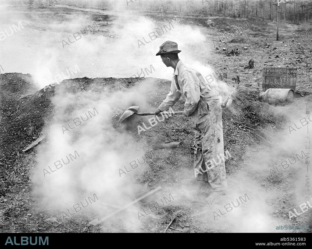 Henry Dukes, U.S. Farm Security Administration (FSA) borrower, burning Charcoal, Heard County, Georgia, USA, Jack Delano, U.S. Farm Security Administration, April 1941.