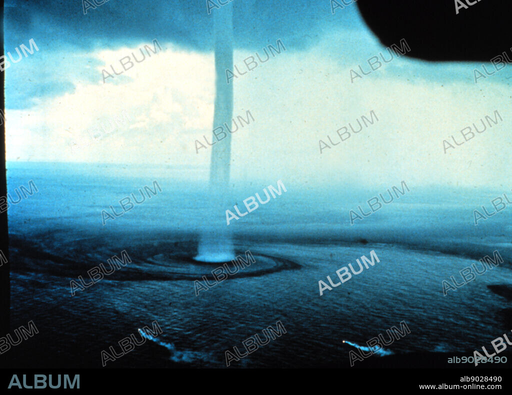 A waterspout, a type of tornado that occurs over water. Waterspouts are spinning columns of rising moist air that typically form over warm water. Waterspouts can be as dangerous as tornadoes and can feature wind speeds over 200 kilometers per hour. Many waterspouts form away from thunderstorms and even during relatively fair weather. Waterspouts may be relatively transparent and initially visible only by the unusual pattern they create on the water. The above image was taken in 1969 from an aircraft off the Florida Keys,.