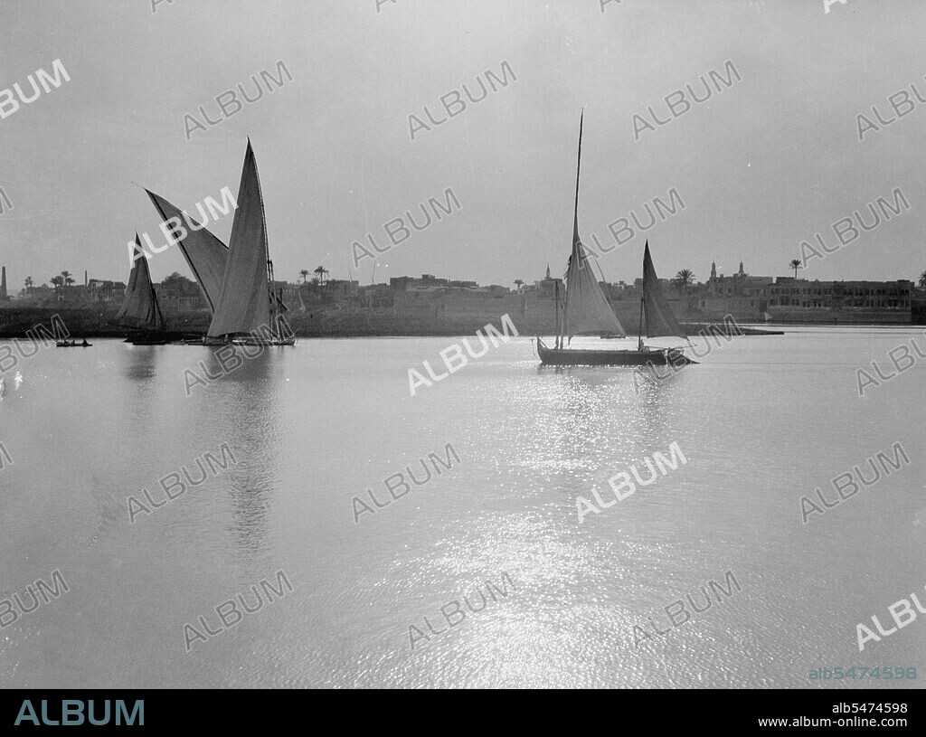 Scene along the Cairo banks of the Nile River, many sailboats on the river  ca. between 1934 and 1939.