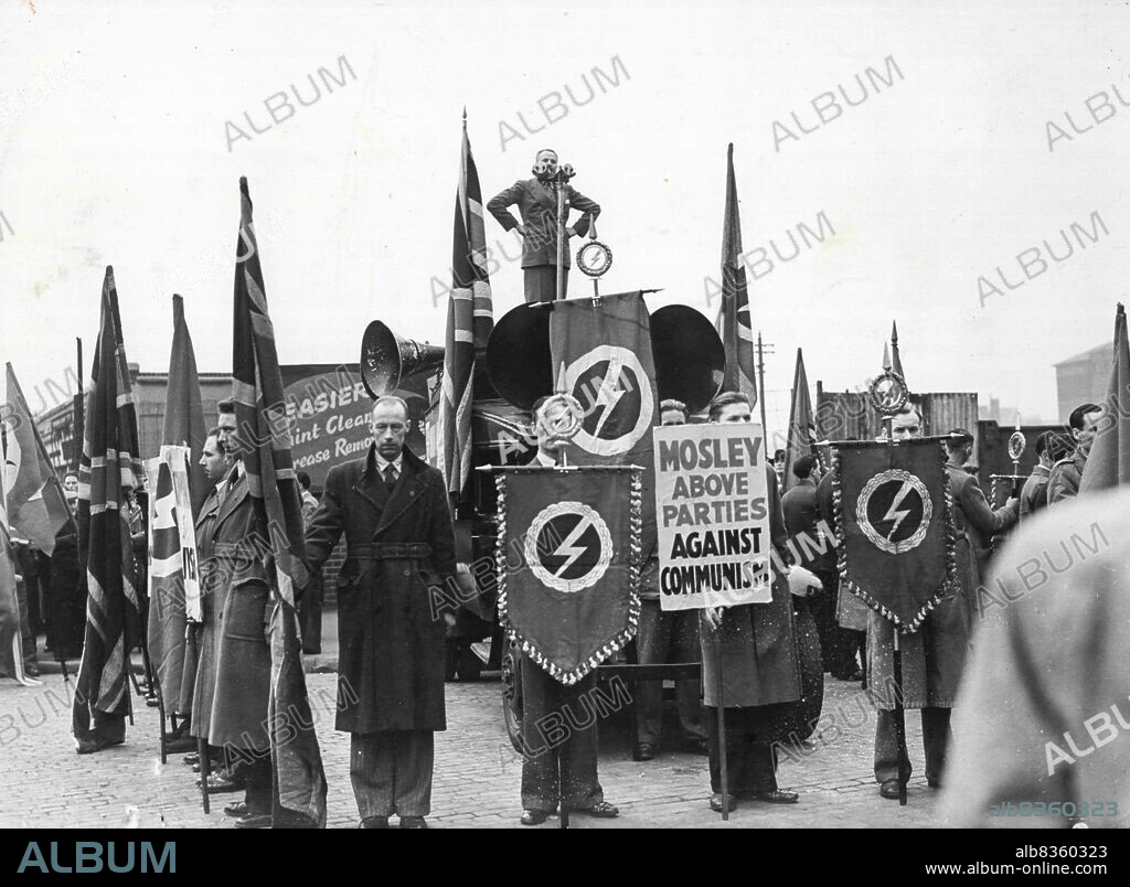 Sir Oswald Mosley Speaks at Dalston.Sir Oswald Mosley addressing the meeting. Banners hang in front of his loud speaker van.Sir Oswald Mosley this afternoon addressed a meeting at Ridley road, Dalston. May 7, 1950. (Photo by Paul Popper Ltd.).