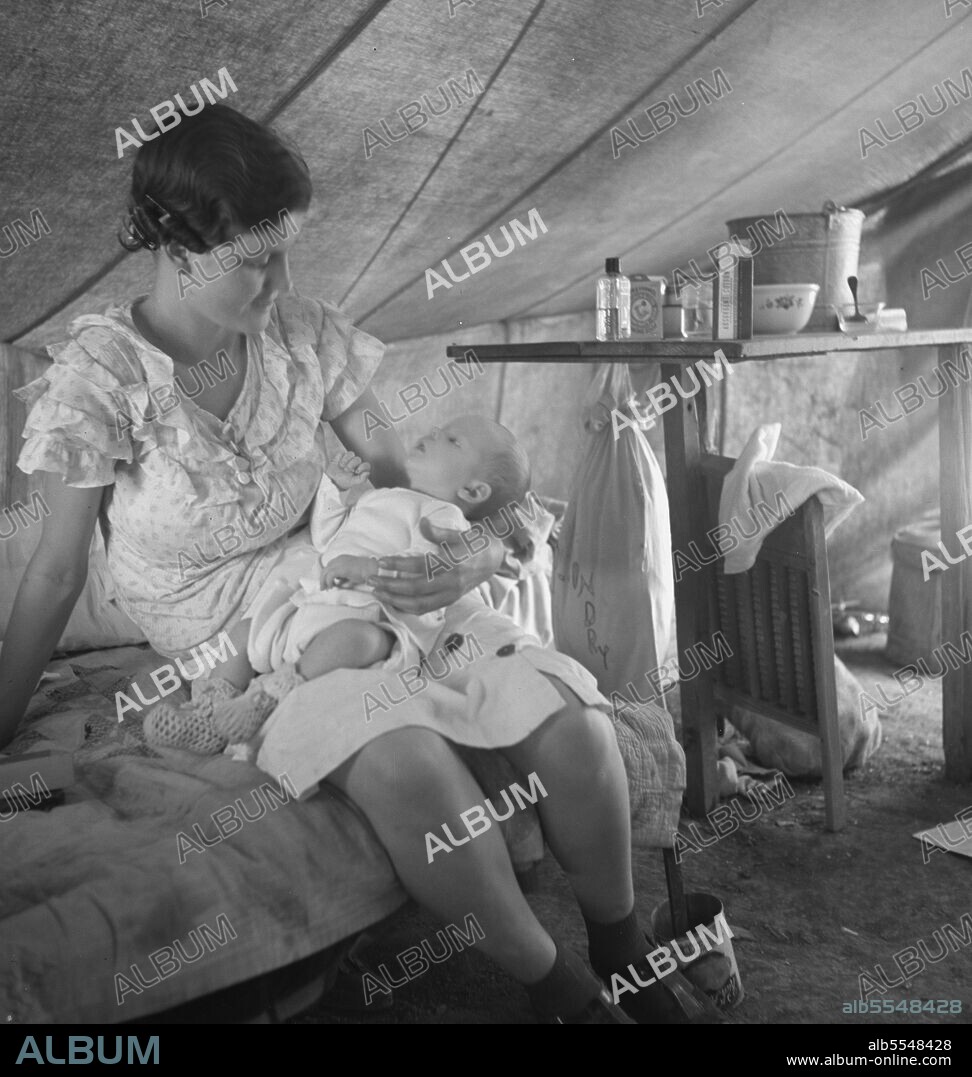 DOROTHEA LANGE. Young migrant mother with six weeks old baby born in a hospital with aid of Farm Security Administration (FSA) medical and association for migratory workers. She lives in a labor contractors camp near Westley, California. "I try to keep him eatin' and sleepin' regular like I got him out of the hospital.".