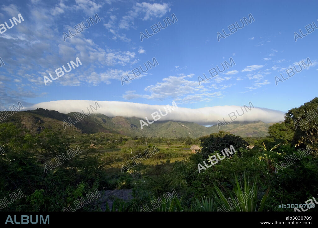 Cloud formation over the coastal mountain range of southern Madagascar, viewed from the plains SW of Fort Dauphin. Clouds provide rain and mist for cloud forests in the mountains of eastern Madagascar.