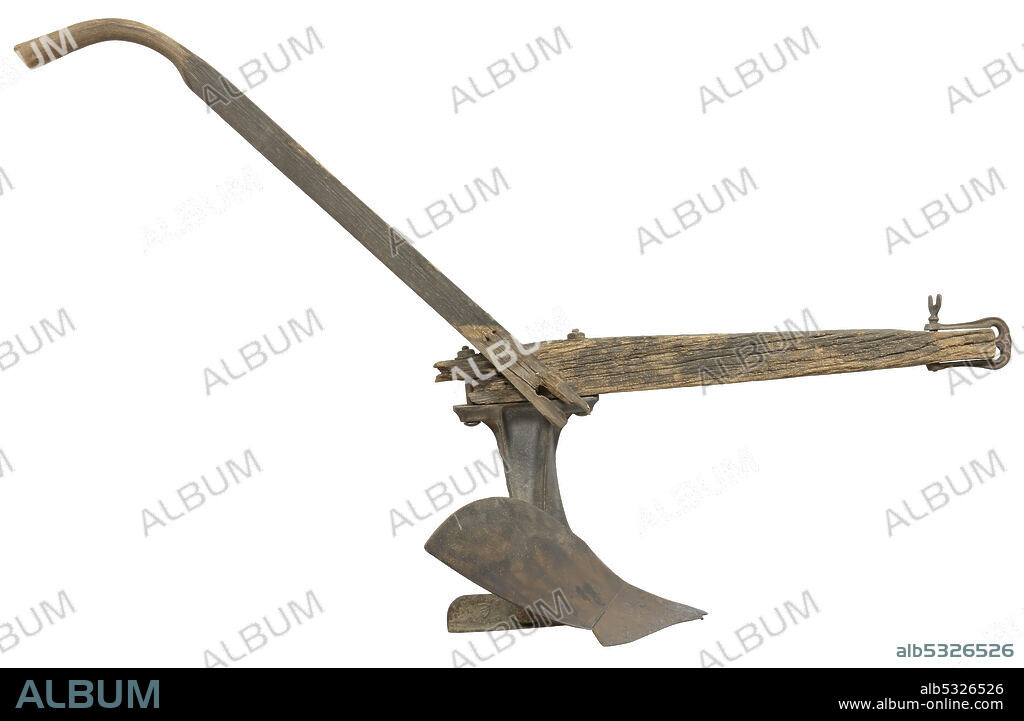 BRINLY-HARDY COMPANY. A steel walking plow with a wood handle and beam owned by Joshua Lyles. The plow has a moldboard on the right side. Embossed on the left side of the plow near the beam is "BRINLY'S / TRADE MARK / BRONCHO." Attached to the plow with metal bolts is a wooden beam. At the front of the beam a metal hitch is attached. A single wood handle is attached to the right side of the beam near the plow.