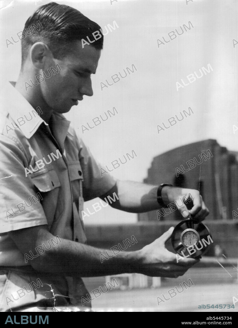 Ken Heath (left) with the anomometer which shows that the wind assisted John Treloar in his 100 Yrds ***** in 9.5. February 25, 1948.