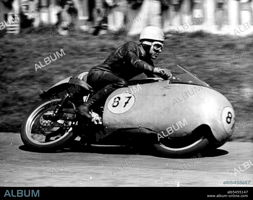 Duke Does It Again -- Australia's Ken Kavanagh at speed during the 350 CC Rave which he won on his Moto-Guzzi.Geoff Duke, Britains world 500 CC Motorcycle champion robe his 500 CC Gilera to Victory in the Rhine cup races at Hockenheim. Germany on Sunday.More than 120,000 fans saw him set up a lap record of 123.8. miles an hour, he covered the 20 laps in 47 minutes 12.5. seconds.Ken Kavanagh of Australia was second in this event and also won the 350 CC race on his Moto-Guzzi at 11.84 miles an Hour. May 10, 1955. (Photo by Paul Popper Photo, Paul Popper Ltd.).