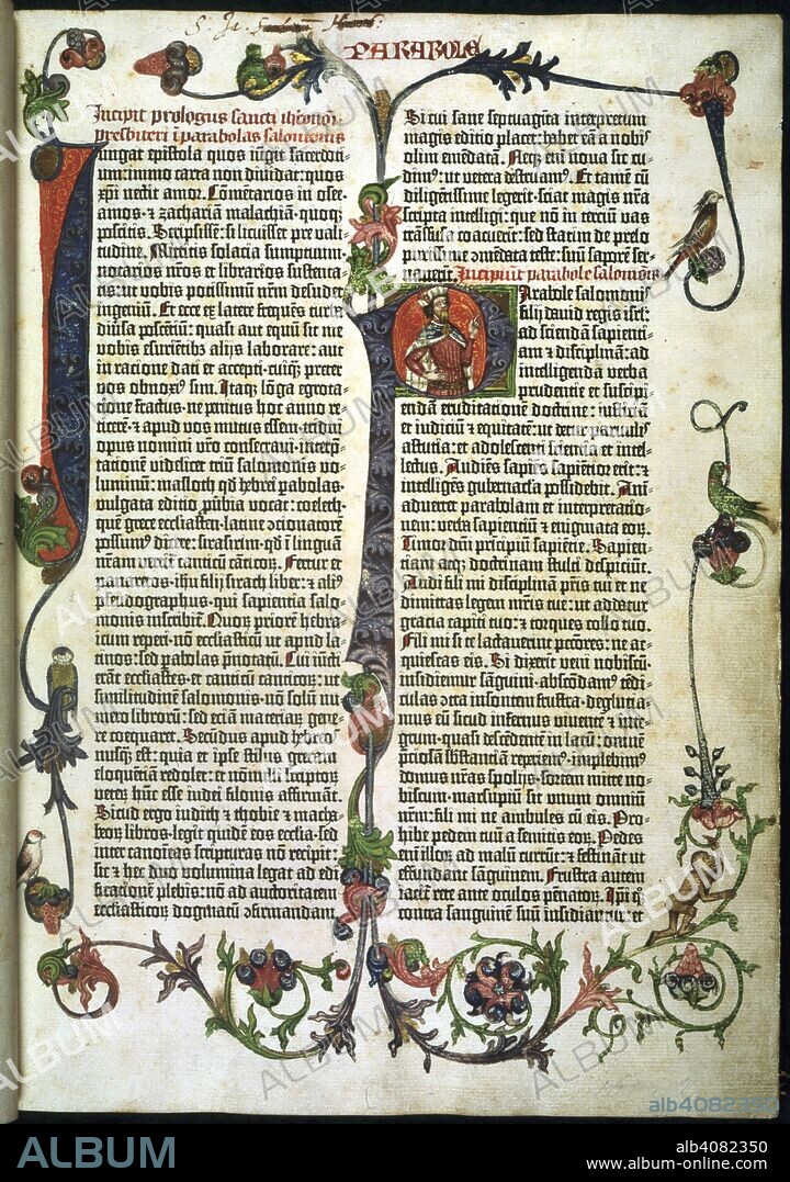 Parabole or Proverbs. In the Gutenberg Bible. The Gutenberg Bible, the Mazarine Bible and the 42-line page Bible. Mainz, 1455. The opening page of the second volume, Parabole or Proverbs. A letter 'I' has been supplied in the inner margin in red and blue, with gold pen-work in the red area, and in the blue area with scrolling foliage in a lighter blue, highlighted in grey. In the second column a 6-line letter 'P' has also been supplied in the style and palette of the 'I', and extending into the space between the columns. Within the letter, on a red background with gold pen-work, there is a bearded figure (King Solomon) in a white hat (crown?), and clad in a red and white cape over a maroon tunic decorated with gold pen-work. A full border in the style and palette of the preceding two decorated pages; in addition to perching birds there is a climbing monkey. Other initials are less ambitiously decorated. Source: C.9.d.4, title page.