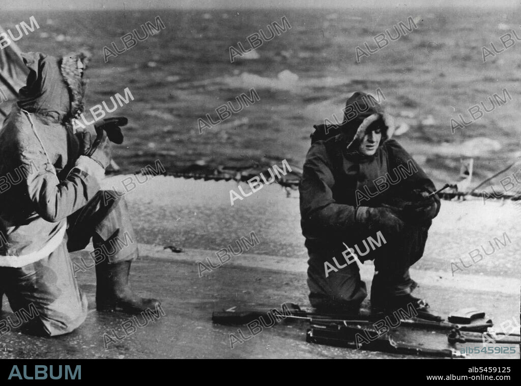 Royal Navy Tests Fighting Efficiency in Arctic - Royal Marines, in Arctic clothing prepare to fire a Bren light machine gun from H.M.S. 'Vengeance'.With Royal Navy Arctic Force: For six weeks, units of the Royal Navy, including the light carrier Vengeance, two destroyers, a frigate and other small vessels have carried out endurance tests in these freezing waters, testing the fighting efficiency of men and ships over long periods of extreme cold. Weapons and personal equipment were rigorously tested. March 10, 1949. (Photo by British Official Photograph).