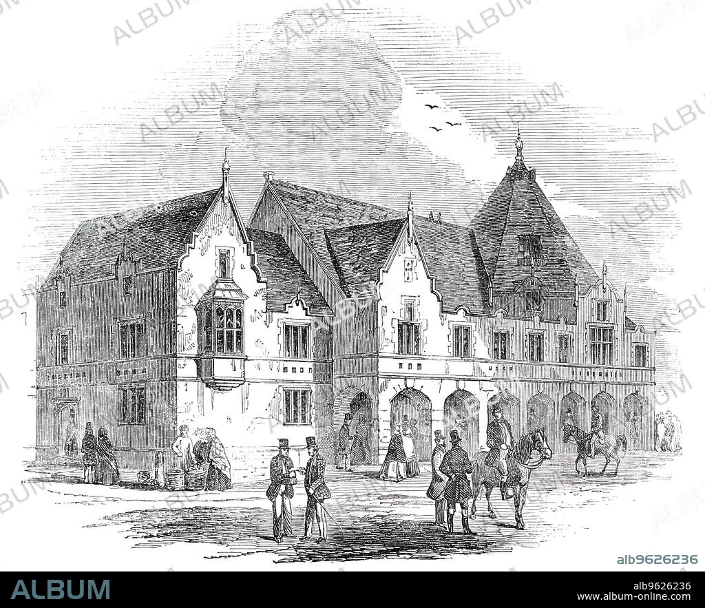 The Corn Exchange and Market Hall, just erected at Lichfield, [Staffordshire], 1850. 'In 1848, the present Mayor of Lichfield formed the project of a Corn Exchange and Market Hall, and by his energy...the present building was commenced and finished.' View '...from Tamworth-street, [showing] the principal front towards Conduit-street, and the Savings-Bank in Bore-street...The whole of the works were completed by Messrs. Scott and Collyer...The design is by Messrs. Johnson and Son, of Lichfield; the building is in the Elizabethan style, and consists of an arcade extending the entire length of the principal front, which leads into a spacious covered market. The upper room is the Corn Exchange, approached by a broad flight of stone steps, and is 63 feet in length and 34 feet wide. It is calculated to contain from 600 to 800 persons'. From "Illustrated London News", 1850.