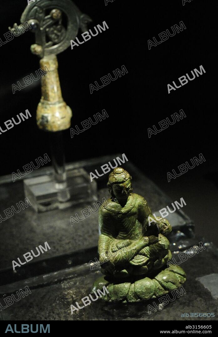 Viking Age. The Helgo Treasure (Island in Ekero Municipallity, Sweden). Irish Crosier Helgo. Irish origin and would have formed part of a bishop's staff. The coiled top of the crozier was made in Ireland around 800 AD. Bronce and decorated with enamel and coloured glass inlays. Buddha statue from India, 6th century. Probably it arrived in Helgo via Swedish merchants. These artefacts could also have arrived on Helgo island either as pillaged goods, during a Viking raid, or exclusive aristocratic gifts. Swedish History Museum. Stockholm. Sweden.