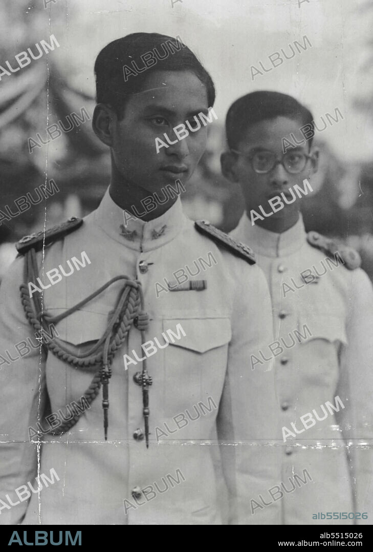 Siam's Boy King Shot Dead - Brother Proclaimed New King.
One of the last pictures of the late King ***** of Siam, taken in Thailand to ***** late King Ananda Mahidol is seen on the left and the newly appointed king, former prince ***** is seen on the right.
Twenty Year old King Ananda Mahidol of Saim, "Brother of the moon and supreme Arbiter of the tides', was found shot dead in his Palace at Bangkok on June 9. His died of a gun explosion huge crowds gathered near the palace, walking in sorrow. An Emergency session of the the Siamese Parliament Unanimously chose Ananda Rother, 19 years old boston born Prince Rhumifhon Aduldet, to succeed him. June 18, 1946. (Photo by Associated Press Photo).